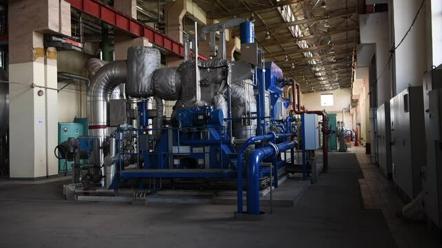 Industrial machines. Internal structure of large thermal power plant. The interior of an industrial boiler room with many pipes, valves and sensors. Lithuania, Vilnius