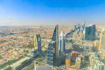 Fototapeta premium Panoramic view of Riyadh, Saudi Arabia, showcasing the vast urban sprawl, bustling streets, and modern architecture under a bright, sunny sky