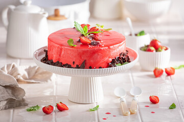 Sweet strawberry cake made of cream, fruits and glaze.