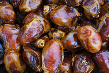 Kurma Sukari or Sukkari Dates Fruit, Textured background. Top view
