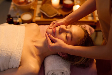 High angle shot of smiling young woman enjoying time at spa salon, she getting anti-aging therapy