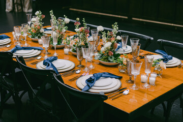 Elegant dining setup with floral arrangements and ornate tableware in a sophisticated venue