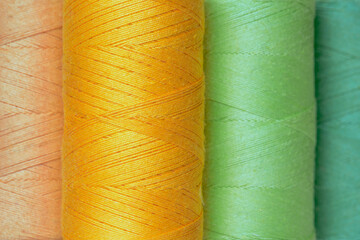 Multicolor reels of sewing threads background