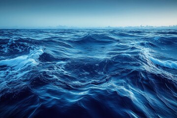 Fototapeta premium Turbulent Deep Blue Ocean Water with Dynamic Waves and Whitecaps Underneath a Cloudy Sky Creates a Natural and Dramatic Seascape
