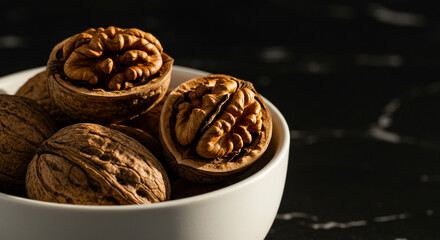 A close-up shot of whole and cracked walnuts 