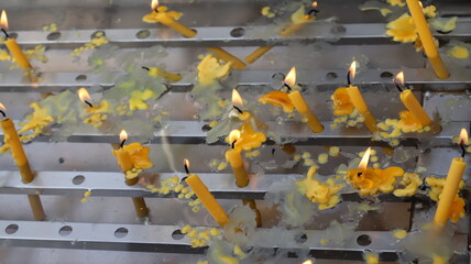Candles lit for worshiping sacred beings according to Buddhist beliefs