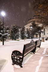 Winter in Bucharest. The Romanian Athenaeum covered in fresh snow at night, with snowfall adding a...