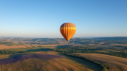 Obraz premium Hot Air Balloon Over Lavender Fields with Rolling Hills and Clear Blue Sky Aerial View
