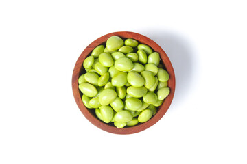 Soy beans edamame in a wooden bowl isolated on white background. Fresh soy beans edamame. Top view