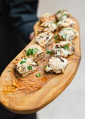 Succulent appetizers served on a wooden platter during a casual gathering in an outdoor setting