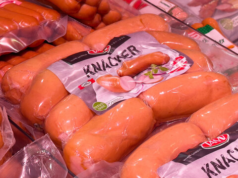 Packaged knacker sausages in refrigerated display at grocery store