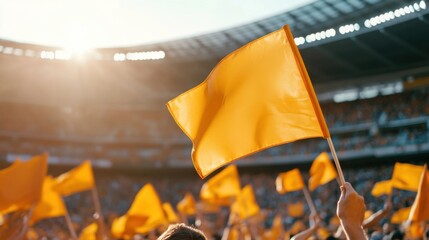 College stadium with the fans waving team flags during the game. Featuring enthusiasm and support
