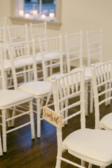 Elegant reserved seating arrangement in a softly lit indoor venue for a special occasion