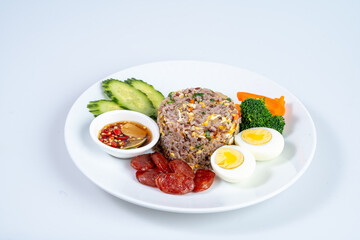 Delicious fried rice served with sliced cucumbers, broccoli, carrots, and boiled eggs, accompanied by flavorful dipping sauce