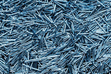 Shredded metal wire pieces texture. Industrial scrap metal background. Raw metallic pattern with...