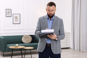Real estate appraisal. Inspector with clipboard conducting property valuation indoors, space for...