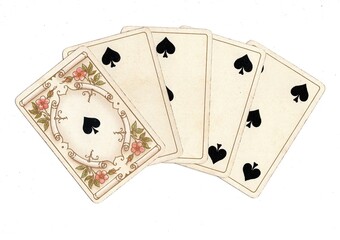 Obraz premium A poker hand of antique playing cards on a white background.