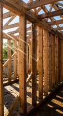 Fototapeta premium A wooden framework in sunlight, symbolizing structural drying after water damage. 