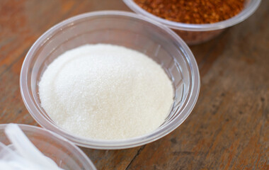 White granulated sugar in a clear plastic cup