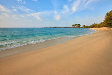 Tranquil Hawaii Beach with Sunny Blue Sky, Calm Ocean Waves, and Golden Sand: Scenic Tropical Island Paradise Seascape