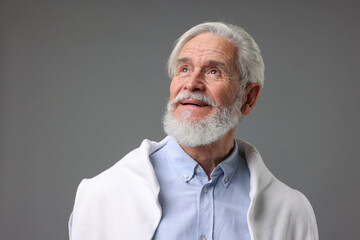 Portrait of stylish bearded man on grey background
