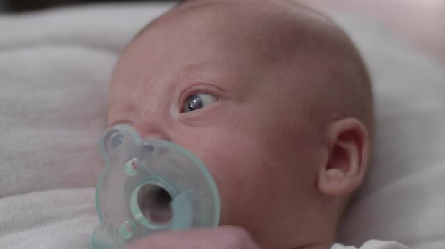 Cute Little Infant Boy Sucking on Pacifier