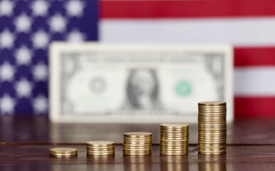 Coins with US dollar bill and flag. Inflation concept, background with copy space.