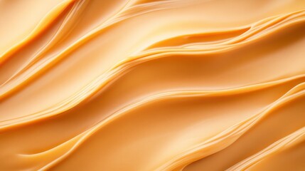 Fototapeta premium Warm caramel tones create a smooth flowing texture that resembles melted candy. This background offers ample copy space perfect for various creative design needs