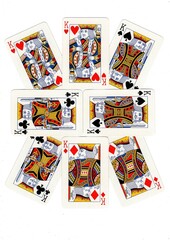 Playing cards arranged in a pattern on a white background.