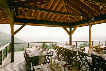 Rustic outdoor dining setup with scenic mountain view for a special gathering in the afternoon light