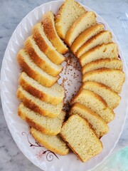 Golden slices of buttery pound cake, arranged in a delightful swirl on a rustic plate. A classic treat that's perfect for any occasion.