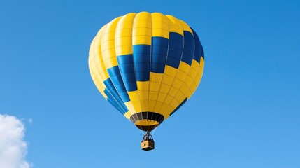 Fototapeta premium Yellow-blue hot air balloon soaring, clear sky, travel adventure