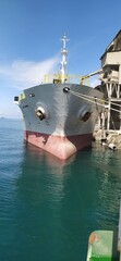 Cargo ship is loading cargo at the dock