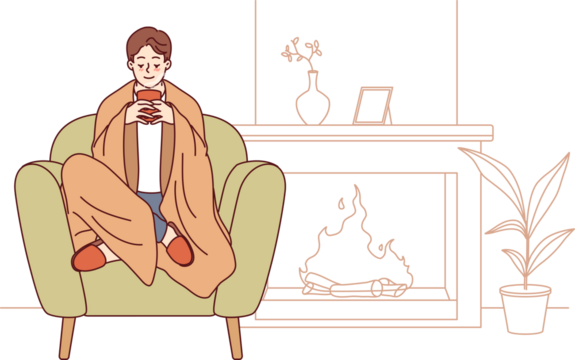 Man feels comfort and harmony sitting by fireplace with blanket on shoulders and cup of hot coffee in hands. Guy enjoys comforts of home and apartment is cozy, allowing him to relax on winter evenings