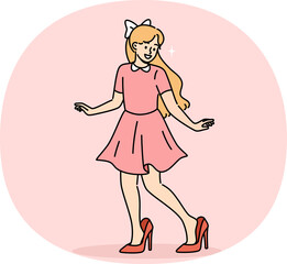 Little fashionista girl tries on mother shoes and smiles, imitating mom and wanting to grow up faster. Funny pre-teen fashionista smiling, imagining walking down catwalk at fashion party
