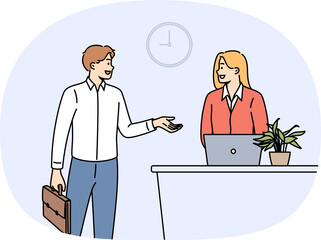 Man rents hotel room talking to administrator standing near reception desk with laptop. Successful businessman checks into hotel during corporate trip to attend professional seminar.