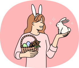 Teenage girl celebrating easter holds decorated eggs in basket and small rabbit, rejoicing at coming of spring. Schoolgirl is preparing for easter and bringing traditional gifts to friends from school