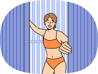 Woman comes out of vertical solarium, urging people to stop sunbathing, which causes skin cancer...