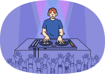 Man DJ performs in nightclub spinning records on mixing console, near crowd of partygoers with hands raised. Cheerful guy DJ in headphones plays dance hits for party or festival visitors