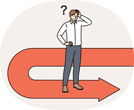 Frustrated businessman has fallen victim to crisis and is forced to move backwards to avoid bankruptcy, scratching head. Sad manager stands on red arrow back symbolizing recession and crisis