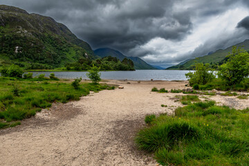 Sandy Beach Of Lake Loch Shiel At Glenfinnan Monument On The Road To The Isles In Lochaber In Scotland, UK
