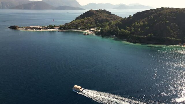 A tranquil bay near Datca with a boat on clear waters, forested hills, and sunny beaches, oe01
