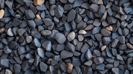 Naklejka premium An assortment of dark stones lies closely packed together showcasing a variety of sizes and textures ideal for use as a background in creative design projects with ample space for text or graphics