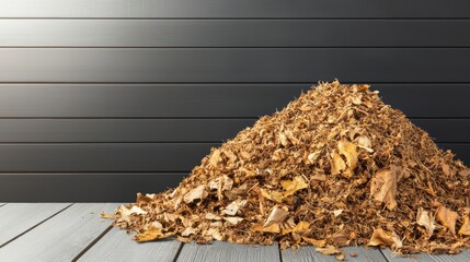 Pile of Dry Autumn Leaves on Wooden Floor Against a Dark Wall Background in Natural Light