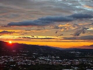 Golden Sunset Over City and Distant Mountains