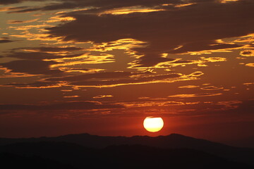 Golden Hour Sunset: Silhouetted Hills Under a Fiery Sky