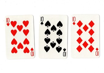 Playing cards showing three of the same value on a white background.