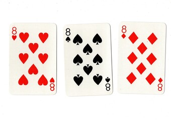 Playing cards showing three of the same value on a white background.