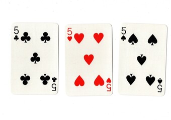 Playing cards showing three of the same value on a white background.