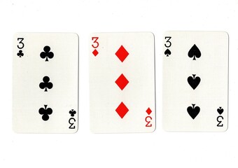 Playing cards showing three of the same value on a white background.